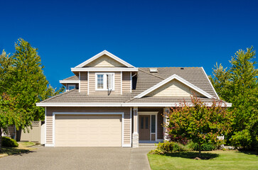 Garage door in luxury house with trees and nice landscape in Summer in Vancouver, Canada, North America. Day time on June 2024.