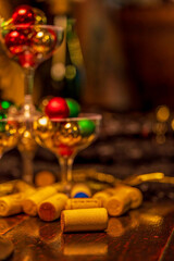 Festive Holiday Drinks Scene with Corks, Champagne Glasses, and Festive Ornaments (Warm Colours)