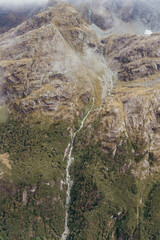 Small waterfall along the Milford sound mountains of New Zealand