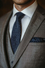 a close photography of a men grey suit
