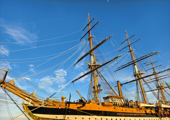 A large old ship at pier under a beautiful blue sky