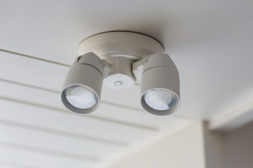 A ceiling-mounted outdoor motion sensor floodlight