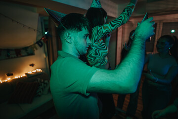 Fototapeta premium Friends enjoying a lively birthday celebration at a home party