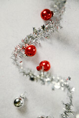 Spiraled silver tinsel with red and silver Christmas ornaments.