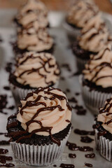 Up close shot of chocolate cupcakes covered in chocolate sauce
