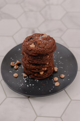 Portrait of a stack of peanut butter cookies on black plate