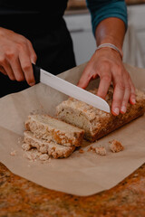 Baker cutting coffee cake on counter