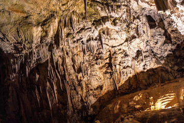Stalactites hanging from the ceiling of postojna cave in slovenia