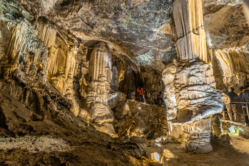 Tourists visiting the impressive postojna cave in slovenia