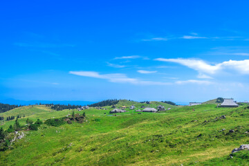 Velika planina mountain pasture showing logarska dolina valley in slovenia during summer © unai