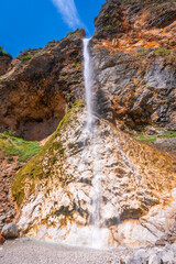 Rinka waterfall cascading down rocky cliffs in logarska dolina valley, slovenia © unai