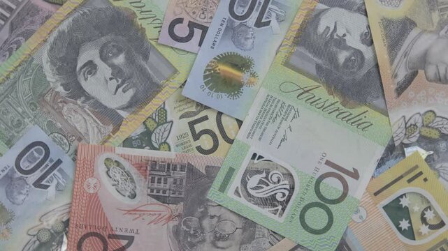 A pile of Australian money is slowly rotating in front of camera in 4k featuring bank notes in values ranging from 5 to 100 dollars