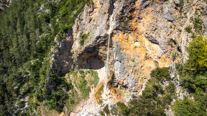 Rinka waterfall cascading into logarska dolina valley in slovenia during summer © unai