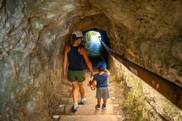 Mother and son exploring tolmin gorge in slovenia