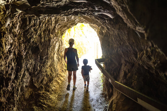Family exploring tolmin gorge cave in slovenia during summer vacation