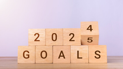 2025 goals concept. Wooden blocks changing from 2024 to 2025. Business growth, goals, planning, Happy New Year