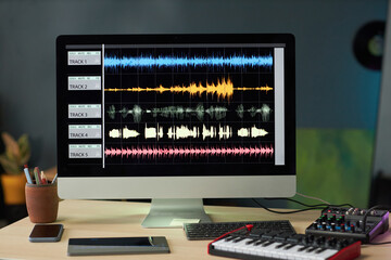 Workplace of composer with computer monitor in professional recording studio