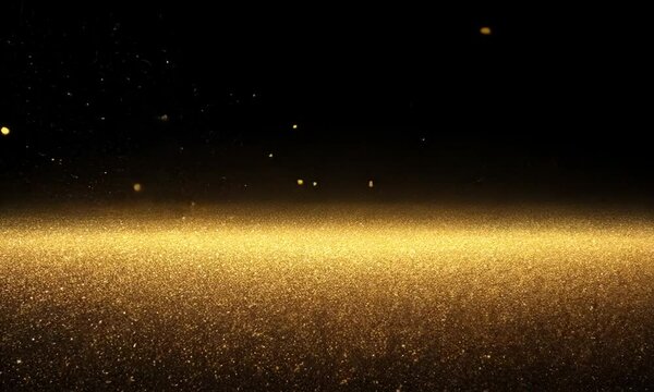 A shimmering cosmic scene filled with stars and golden particles against a black background.