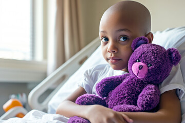 African American Child sick with cancer holding purple teddy bear while sitting on hospital bed in a room. World Cancer Day concept