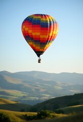 Colorful Hot Air Balloon Soaring Over Scenic Green Valley