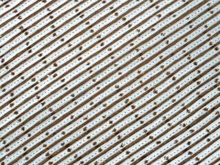 A brown and white striped fabric with a pattern of dots