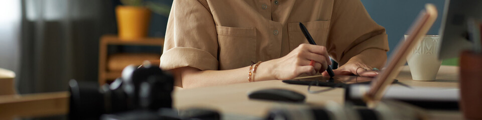 Header with graphic designer working on computer at her workplace