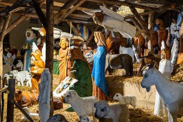 Nativity scene carved from wooden sculptures displayed in the city center at Christmas. Sculptures...