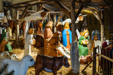 Nativity scene carved from wooden sculptures displayed in the city center at Christmas. Sculptures from biblical stories.