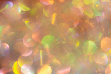 Abstract Christmas background multicolored bokeh. Unusual, sparkling, iridescent pearls with gold...