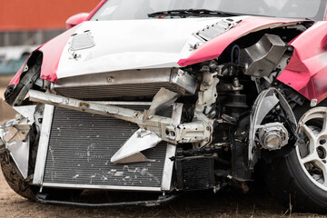 Cropped image of damaged car crash accident on the road.