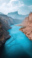 Indus River flows through rugged mountains under a clear sky showcasing contrasting blue waters and arid landscapes