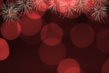 Red firework and blurred bokeh light with copy space in Christmas and New Year. Abstract background holiday concept.