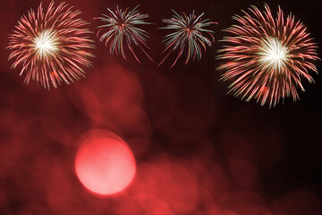 Red firework and blurred bokeh light with copy space in Christmas and New Year. Abstract background holiday concept.