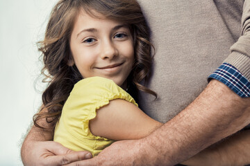 Daughter hugging father, showing love and affection