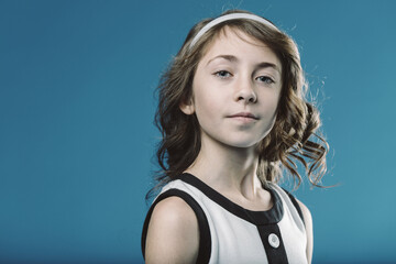 Portrait of smiling young girl with brown hair and white headban