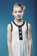 Portrait of smiling young girl with modern dress on blue backgro