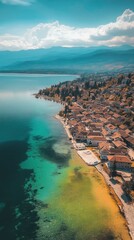Fototapeta premium Stunning aerial view capturing the beauty of Lake Ohrid in Macedonia with vibrant waters and picturesque coastal village