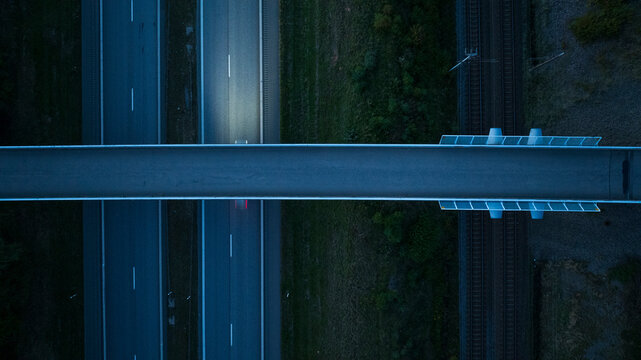 Directly above shot of empty bridge and two lane highway at dusk