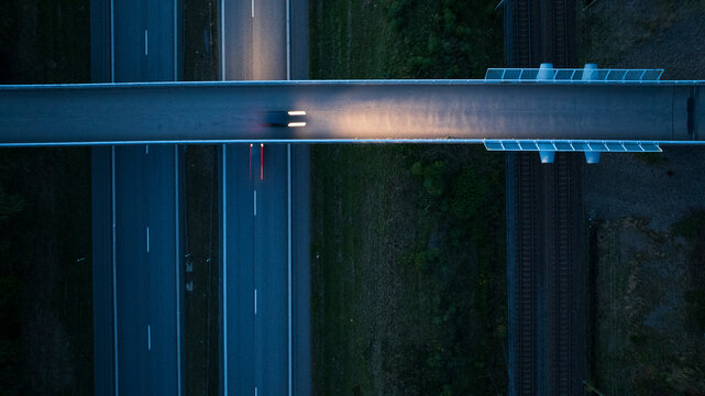 Directly above shot of bridge and two lane highway at dusk