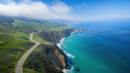 A stunning aerial view of a coastal landscape featuring cliffs, a sandy beach, and a shimmering ocean under a bright sun.