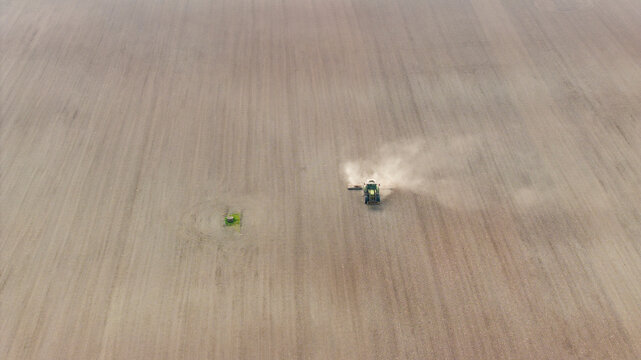 Aerial view of tractor plowing agricultural field