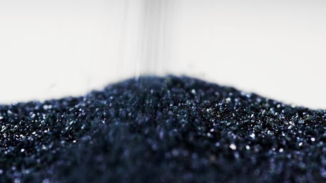 Abrasive powder is poured on the table