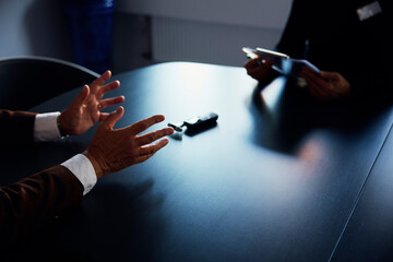 Midsection of medical professional taking history of patient over table in office