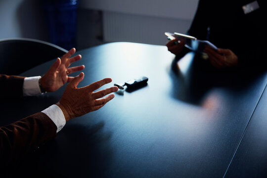 Midsection of medical professional taking history of patient over table in office