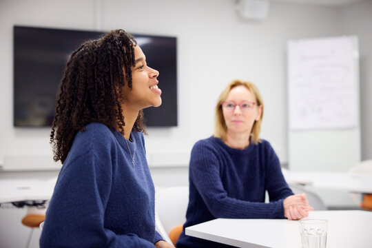Medical student talking with healthcare worker during interview in office