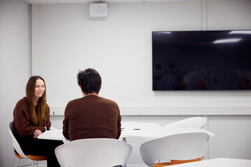 Healthcare manager conducting interview of medical student in office