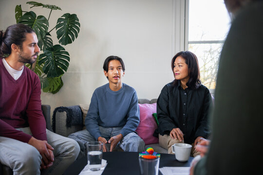 Parents with son sitting in rehabilitation center