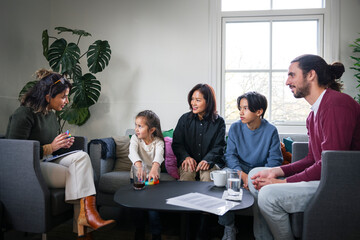 Psychotherapist talking with family during therapy session