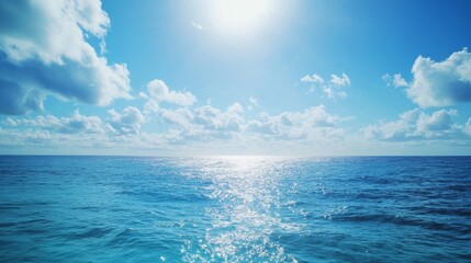 Obraz premium Bright Blue Ocean Under Clear Sky with Sunlight Reflecting on Water Surface and Fluffy Clouds in a Peaceful Atmosphere Captured in High-Resolution Quality