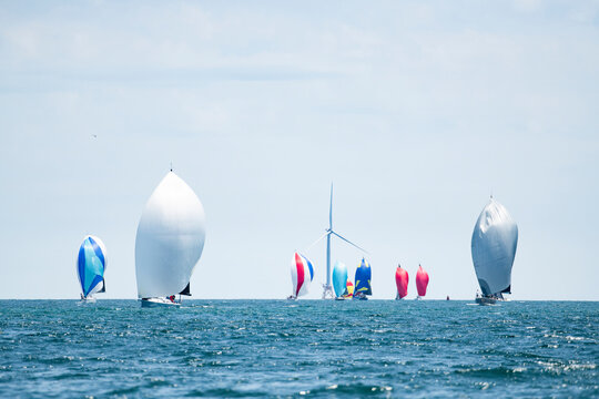 Boats sailing by Wind Turbines in New England